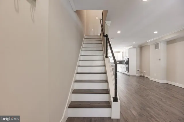 a kitchen with stainless steel appliances kitchen island granite countertop a sink a stove and cabinets