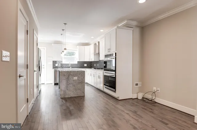 a kitchen with stainless steel appliances a refrigerator and cabinets