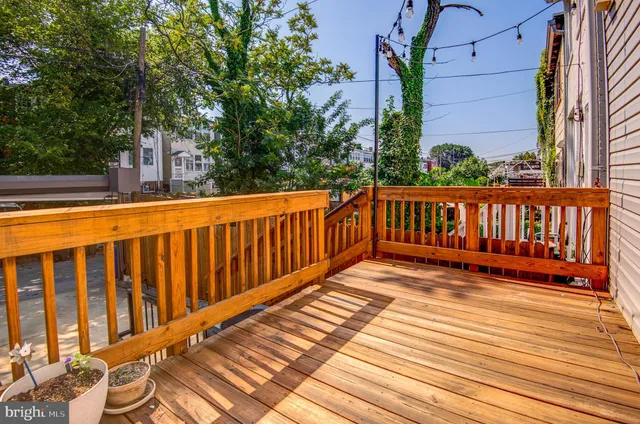 a view of balcony with wooden floor and outdoor seating