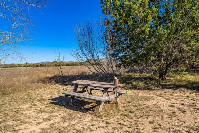 a backyard of a house with lots of trees