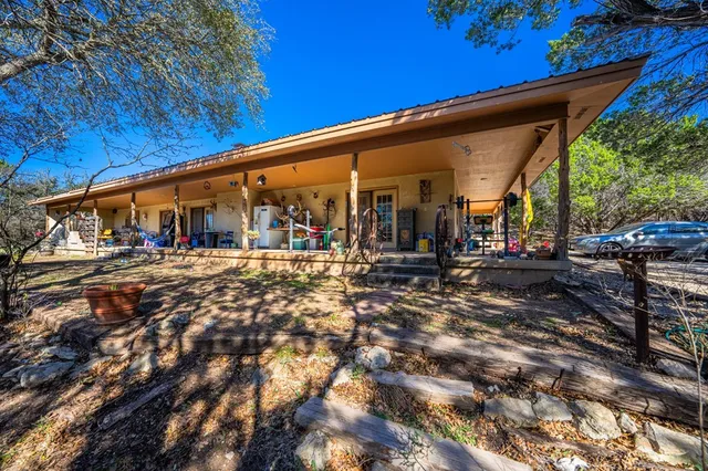 a view of house with outdoor space and sitting area