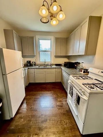a kitchen with a stove a sink and a refrigerator