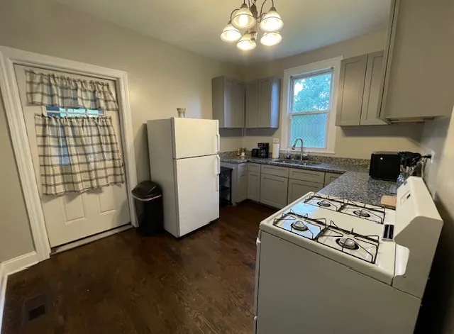 a kitchen with a refrigerator and a stove top oven