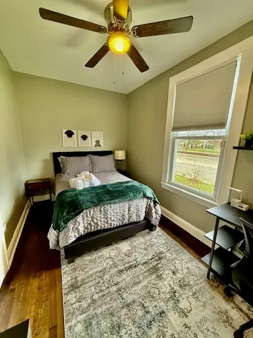 a bedroom with a bed and a chandelier