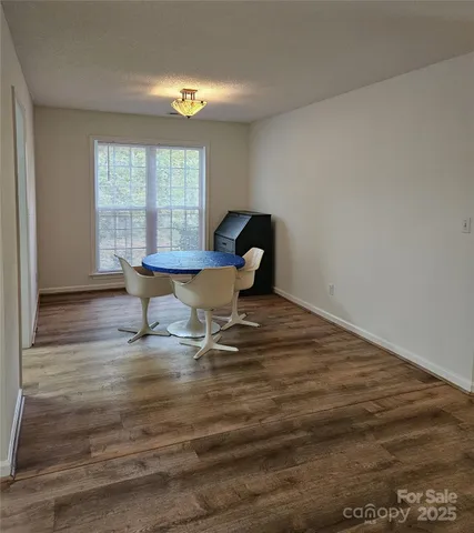 a living room with wooden floor and a table