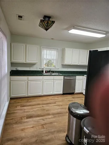 a kitchen with a sink cabinets and window