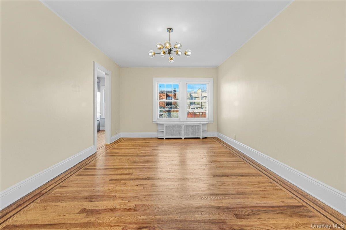 179-67 Selover Road Queens, NY 11434 - Photo 11 of 49 a view of an empty room with wooden floor and a window