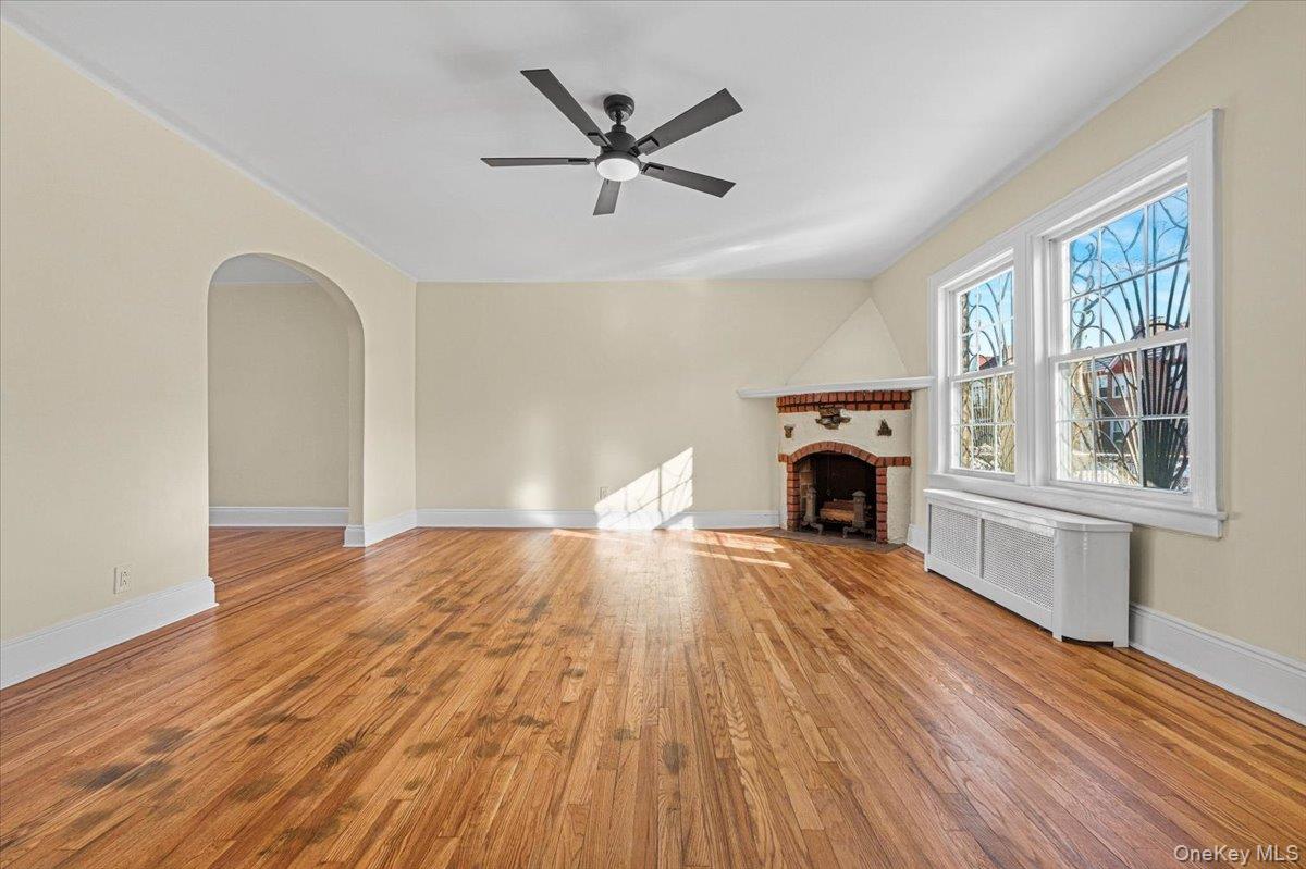 179-67 Selover Road Queens, NY 11434 - Photo 12 of 49 a view of empty room with wooden floor fireplace and windows