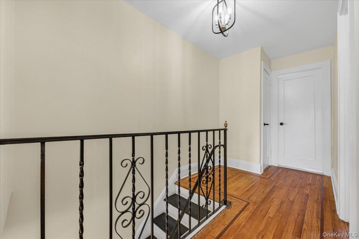 179-67 Selover Road Queens, NY 11434 - Photo 16 of 49 a view of a hallway with wooden floor and chandelier
