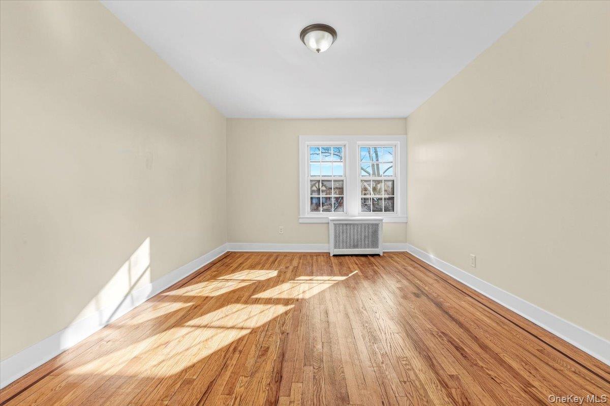 179-67 Selover Road Queens, NY 11434 - Photo 20 of 49 an empty room with wooden floor and windows