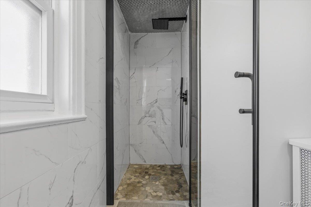 179-67 Selover Road Queens, NY 11434 - Photo 27 of 49 a bathroom with a glass shower door