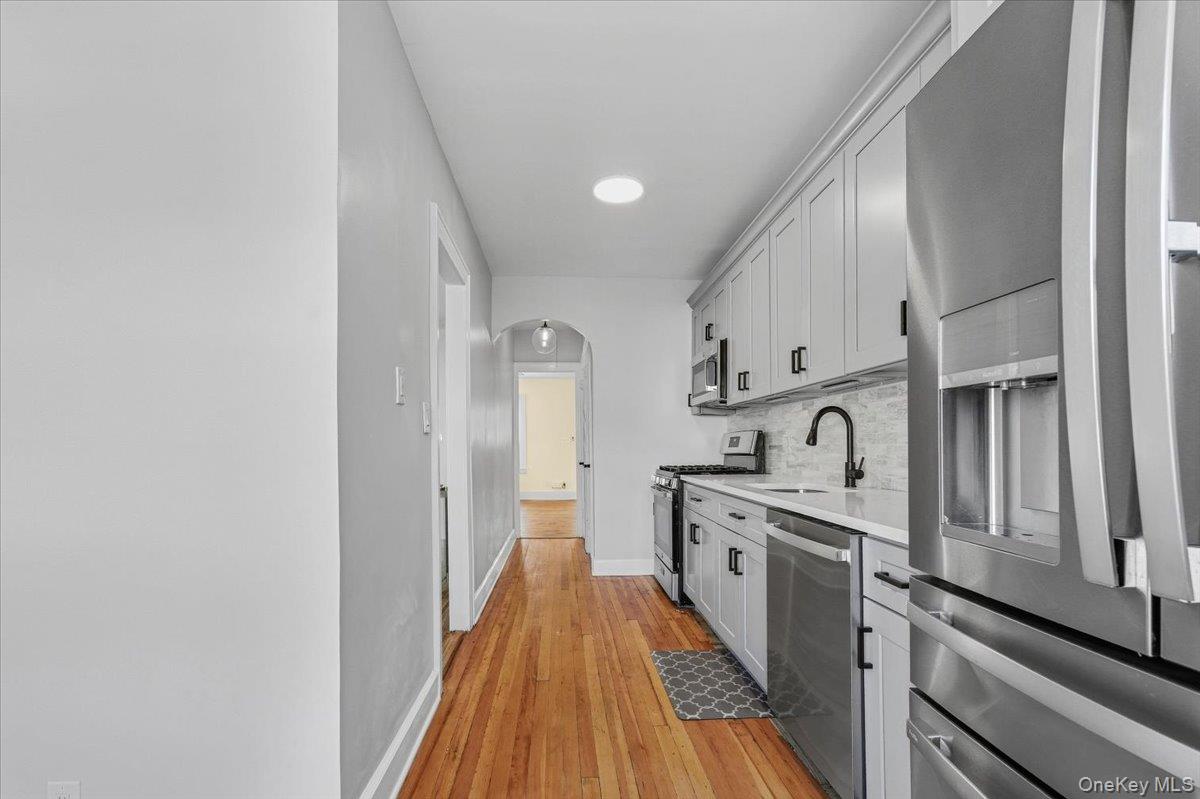 179-67 Selover Road Queens, NY 11434 - Photo 32 of 49 a kitchen with stainless steel appliances granite countertop a lot of cabinets and wooden floor