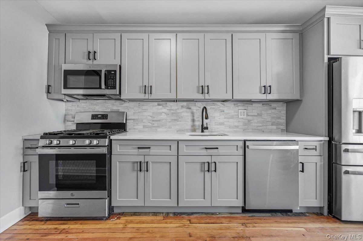 179-67 Selover Road Queens, NY 11434 - Photo 33 of 49 a kitchen with stainless steel appliances granite countertop a stove microwave and refrigerator
