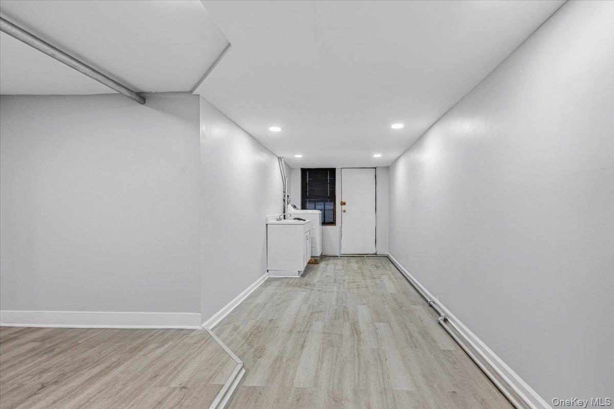 179-67 Selover Road Queens, NY 11434 - Photo 37 of 49 a view of a big room with wooden floor and a kitchen