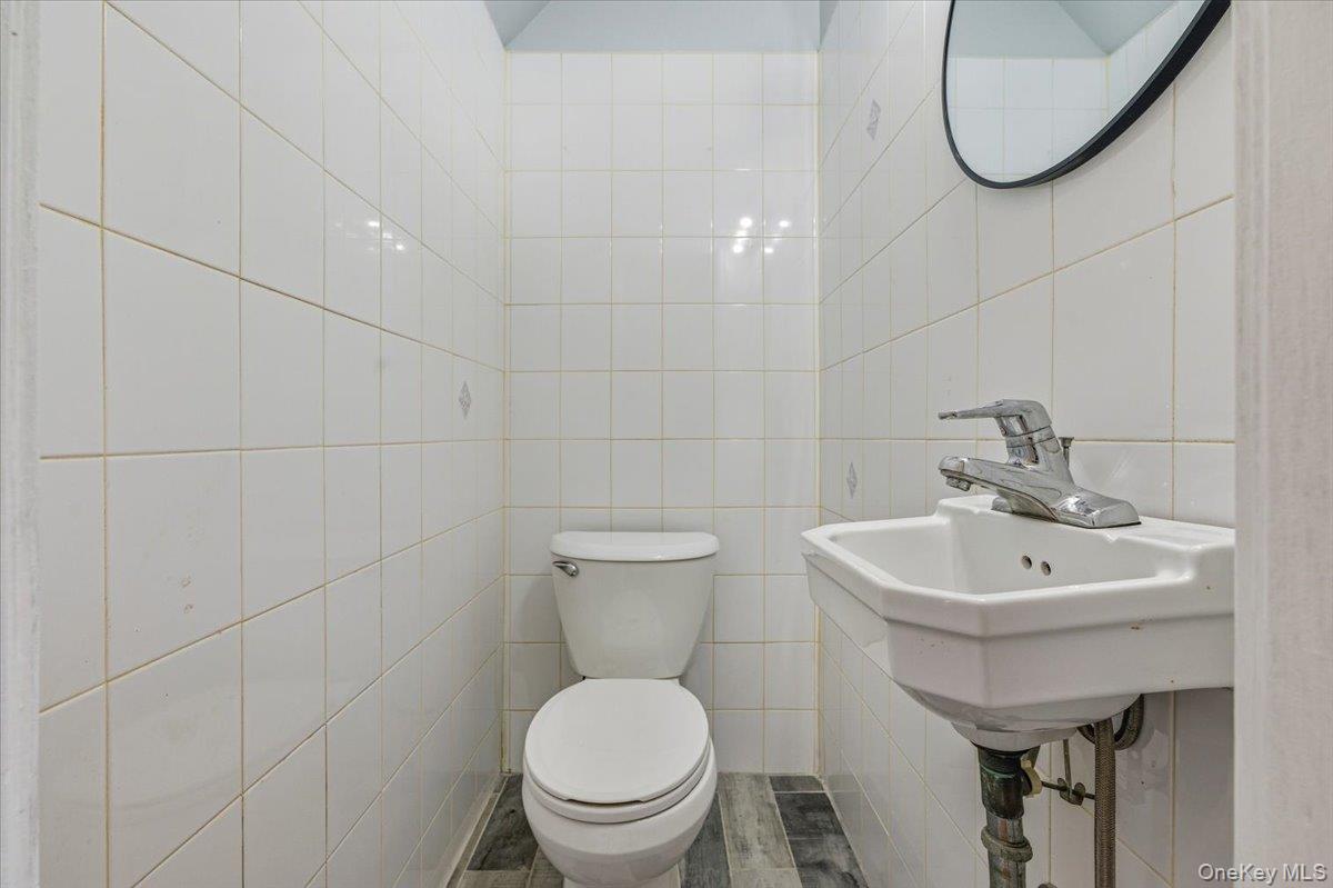 179-67 Selover Road Queens, NY 11434 - Photo 42 of 49 a bathroom with a toilet sink and mirror