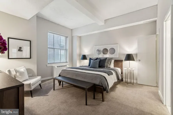 a bed room with a bed and a chair