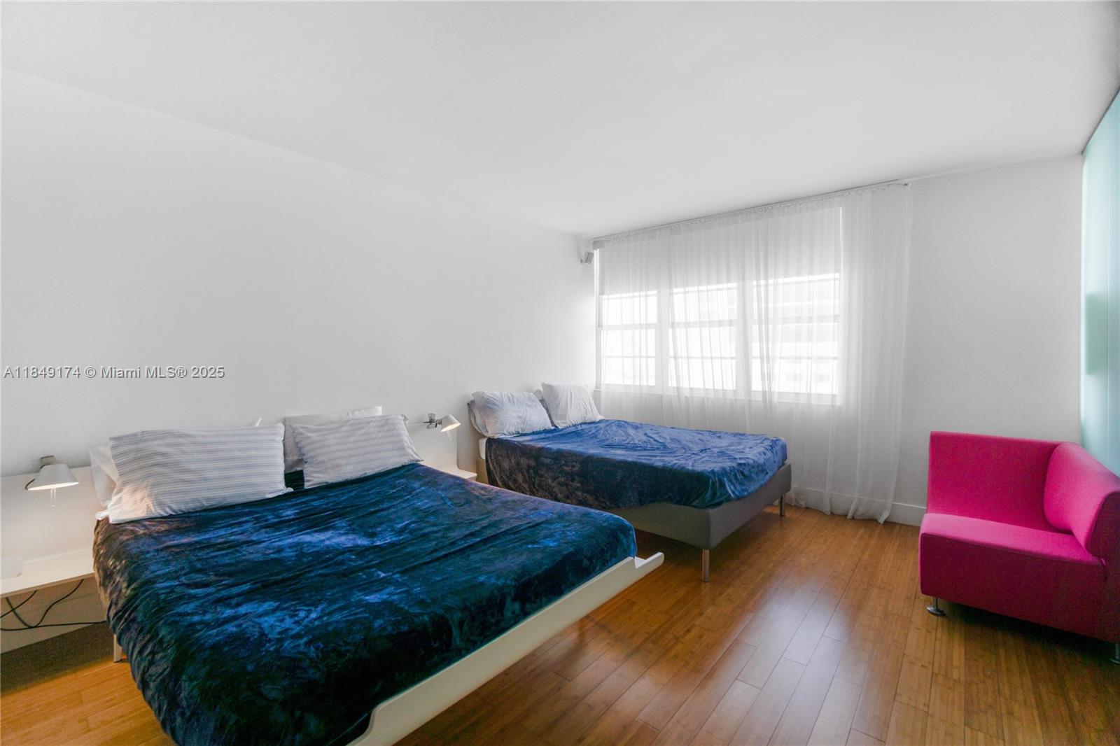 100 Lincoln Road, Unit 923 Miami Beach, FL 33139 - Photo 13 of 31 a bedroom with two beds and wooden floor