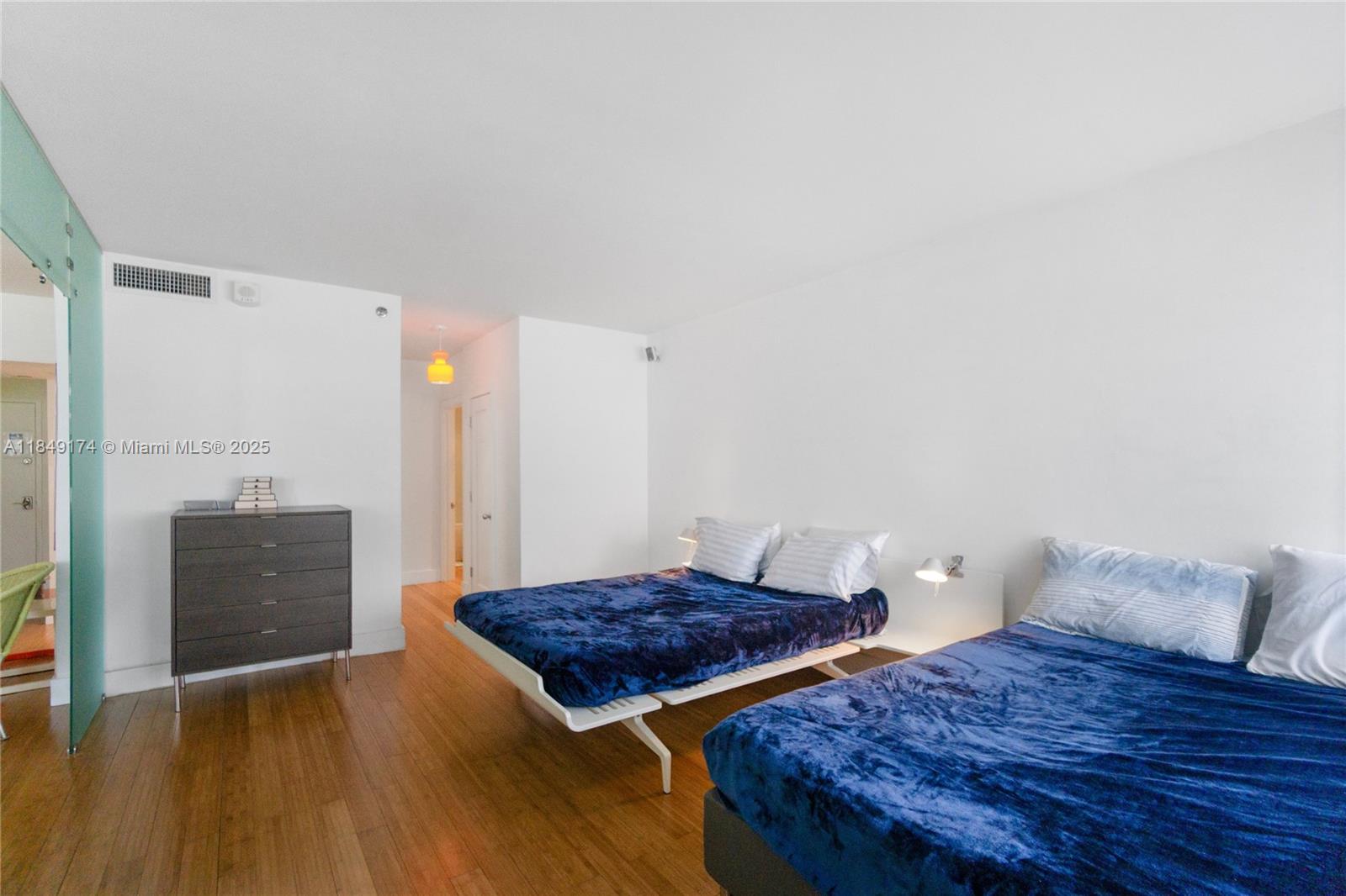 100 Lincoln Road, Unit 923 Miami Beach, FL 33139 - Photo 14 of 31 a bedroom with a bed and wooden floor