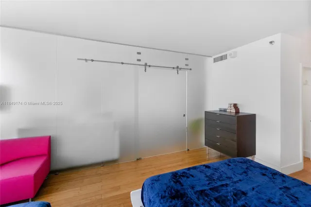 a bedroom with a bed and a chair