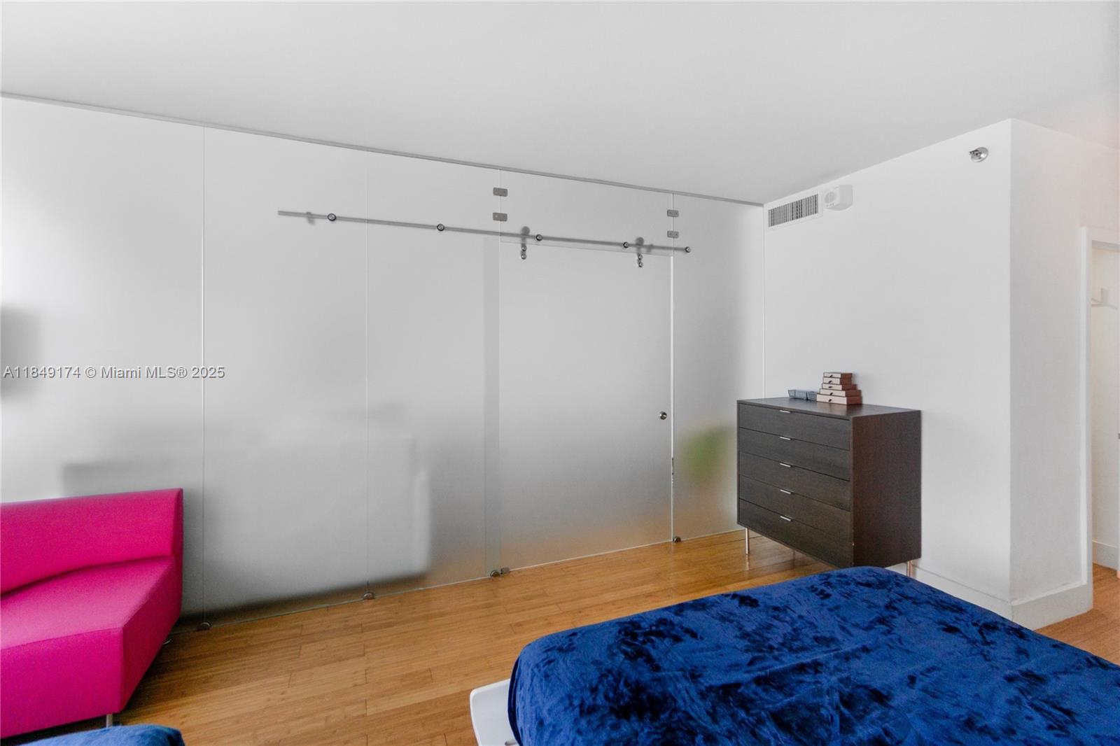 100 Lincoln Road, Unit 923 Miami Beach, FL 33139 - Photo 16 of 31 a bedroom with a bed and a chair