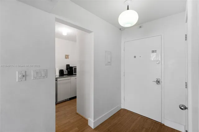 a view of a room with wooden floor