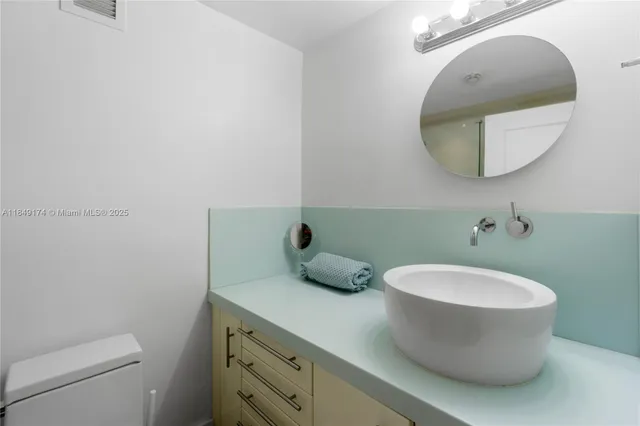 a bathroom with a toilet and a mirror