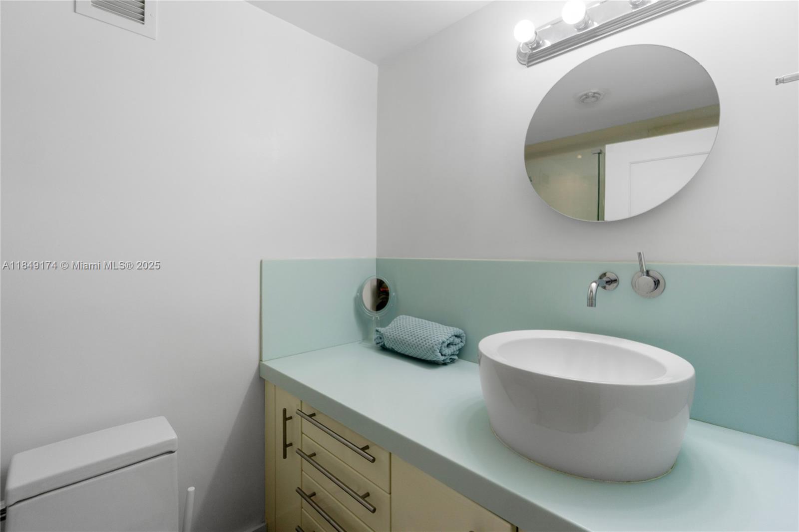 100 Lincoln Road, Unit 923 Miami Beach, FL 33139 - Photo 18 of 31 a bathroom with a toilet and a mirror