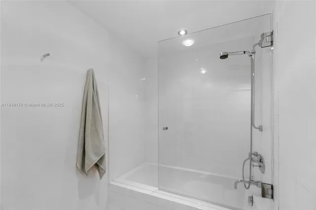 a bathroom with a shower and a bath tub