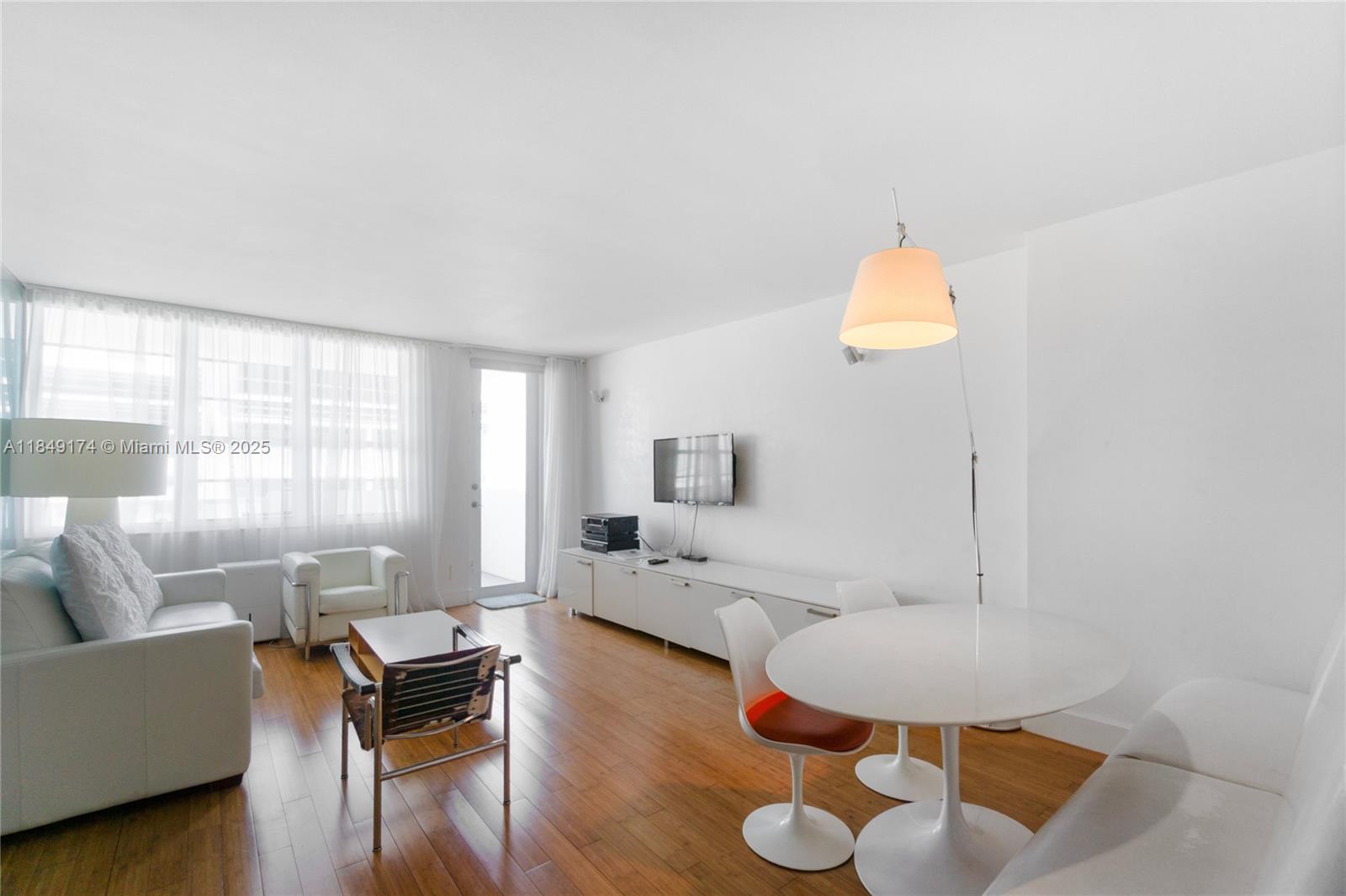 100 Lincoln Road, Unit 923 Miami Beach, FL 33139 - Photo 2 of 31 a living room with furniture and a large window