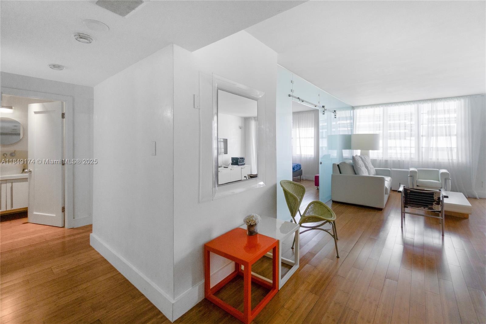 100 Lincoln Road, Unit 923 Miami Beach, FL 33139 - Photo 4 of 31 a living room with furniture and a wooden floor