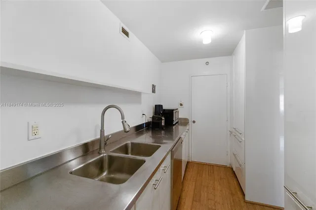 a kitchen with a sink and a refrigerator