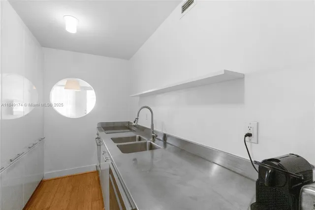 a kitchen with a sink and a stove top oven