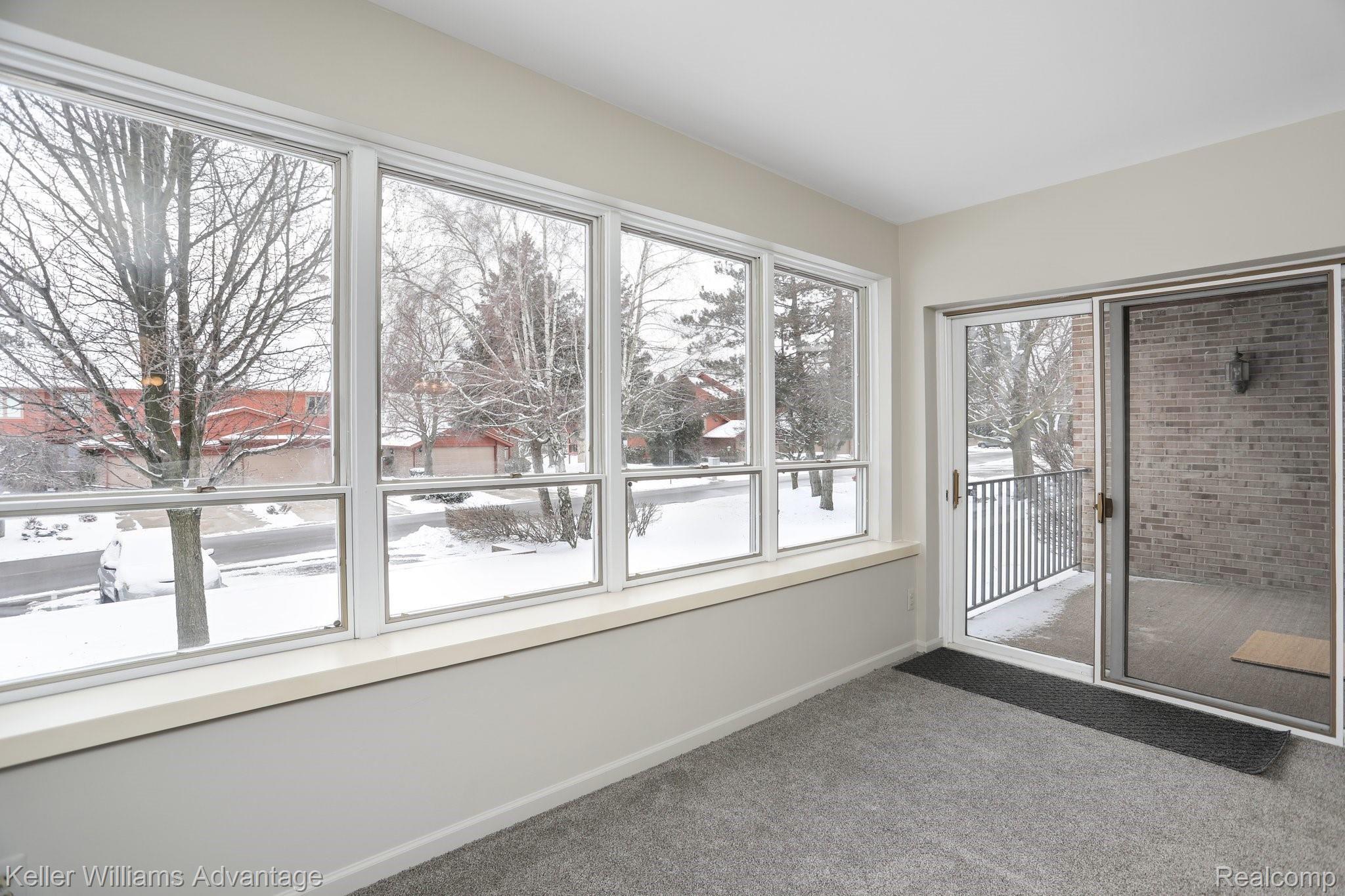 875 GreenView Court, Unit 58 Rochester, MI 48307 - Photo 6 of 27 Great Room featuring ample natural light and sliding door to private patio