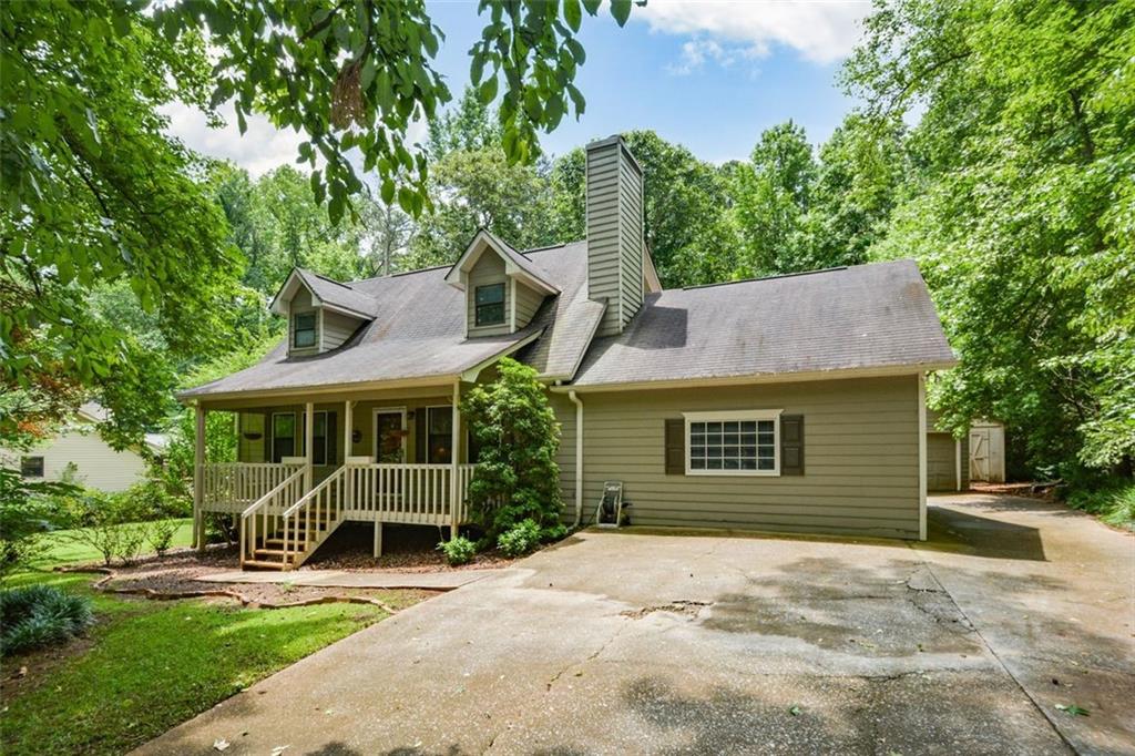 380 Fox Ridge Court Dallas, GA 30157 - Photo 1 of 1 a front view of a house with a garden and plants