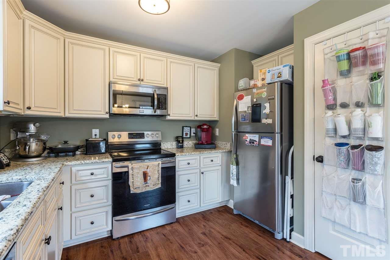 70 Young Road Angier, NC 27501 - Photo 5 of 8 a kitchen with stainless steel appliances granite countertop a refrigerator stove and sink