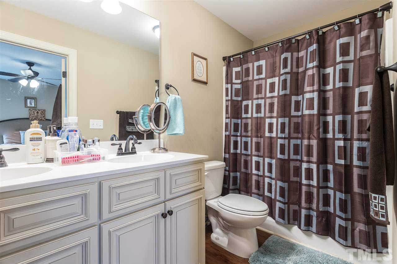 70 Young Road Angier, NC 27501 - Photo 8 of 8 a bathroom with a sink a toilet and shower