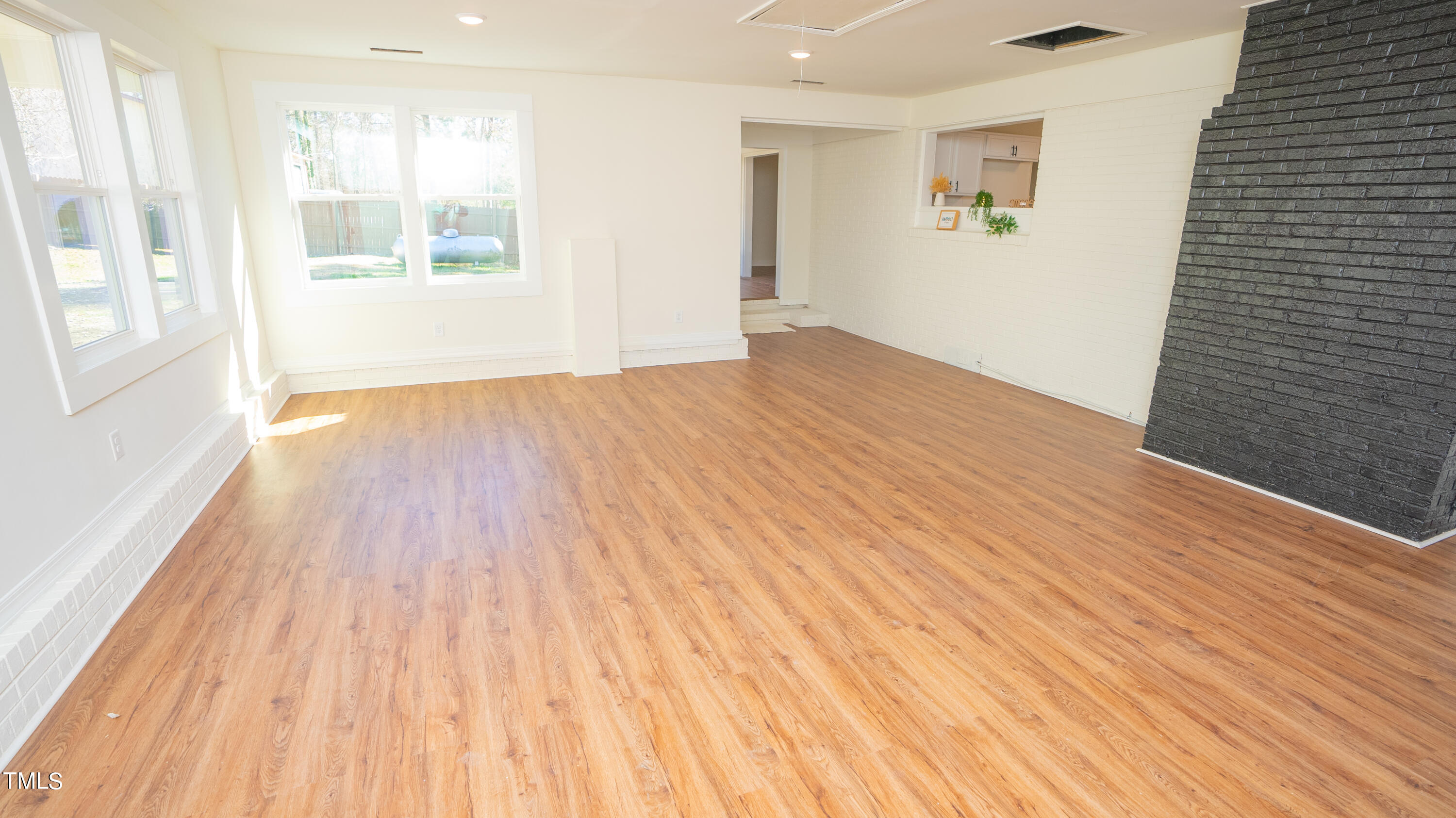 2001 Barwell Road Raleigh, NC 27610 - Photo 13 of 79 a view of an empty room with wooden floor and a window