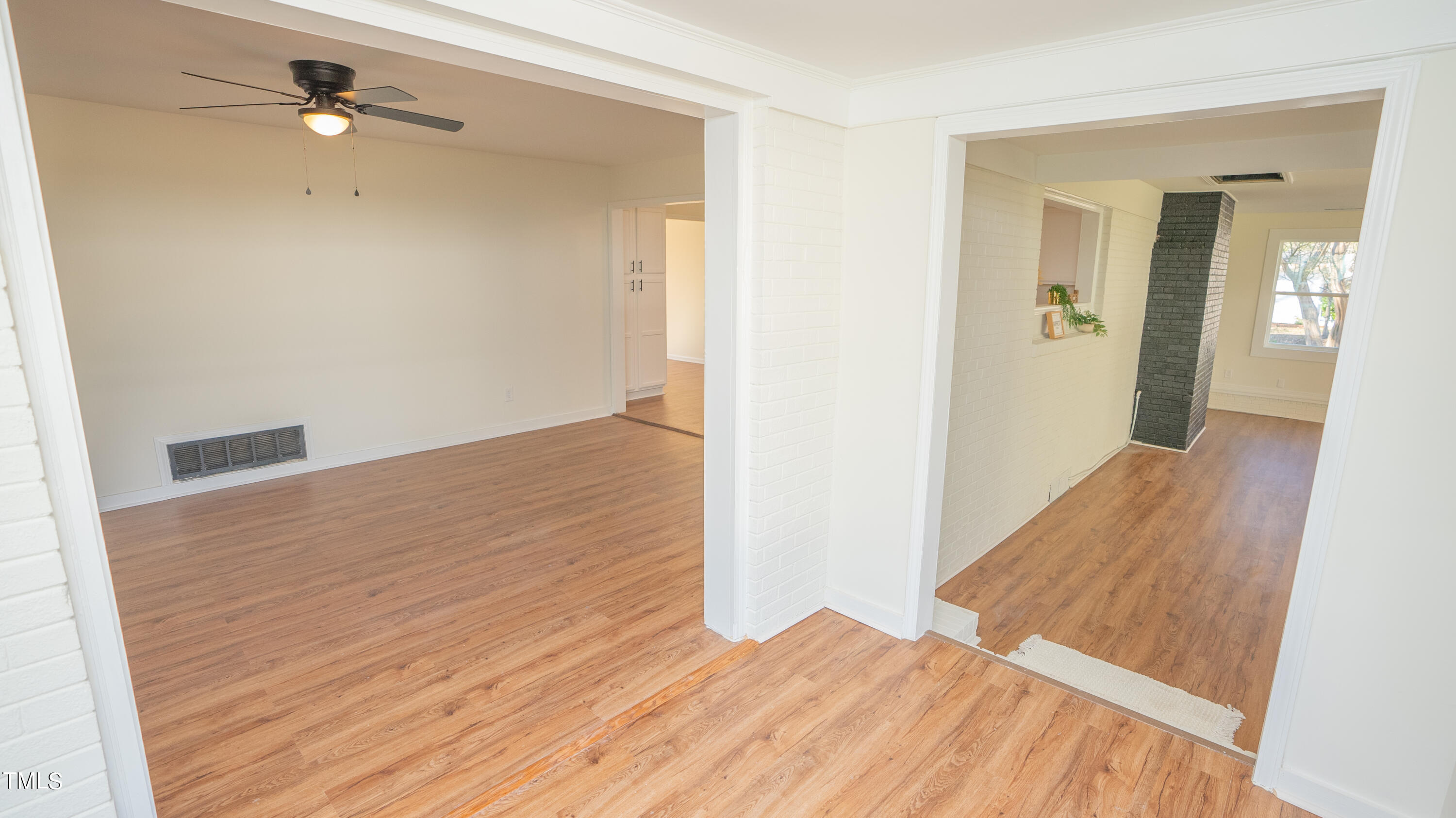 2001 Barwell Road Raleigh, NC 27610 - Photo 19 of 79 a view of a room with wooden floor and a ceiling fan