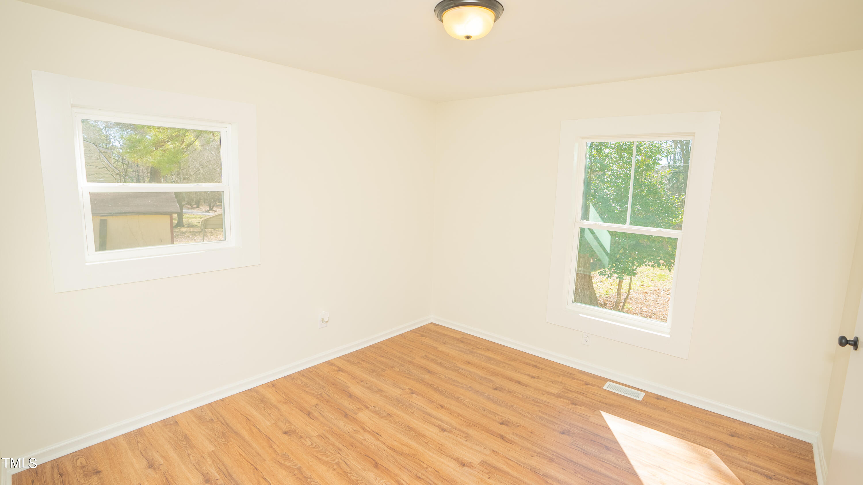 2001 Barwell Road Raleigh, NC 27610 - Photo 25 of 79 a view of an empty room with wooden floor and a window