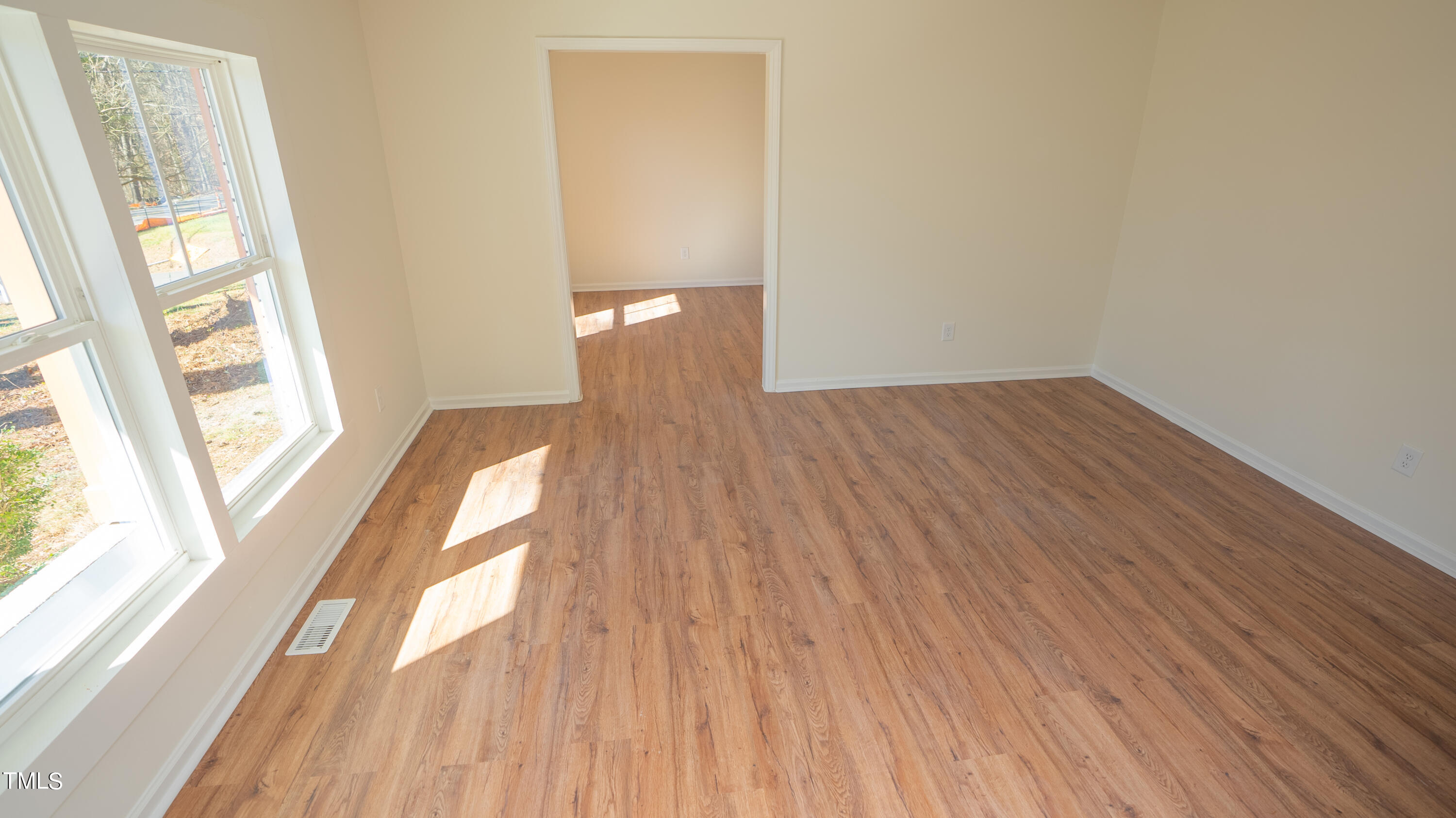 2001 Barwell Road Raleigh, NC 27610 - Photo 35 of 79 a view of empty room with wooden floor and fan