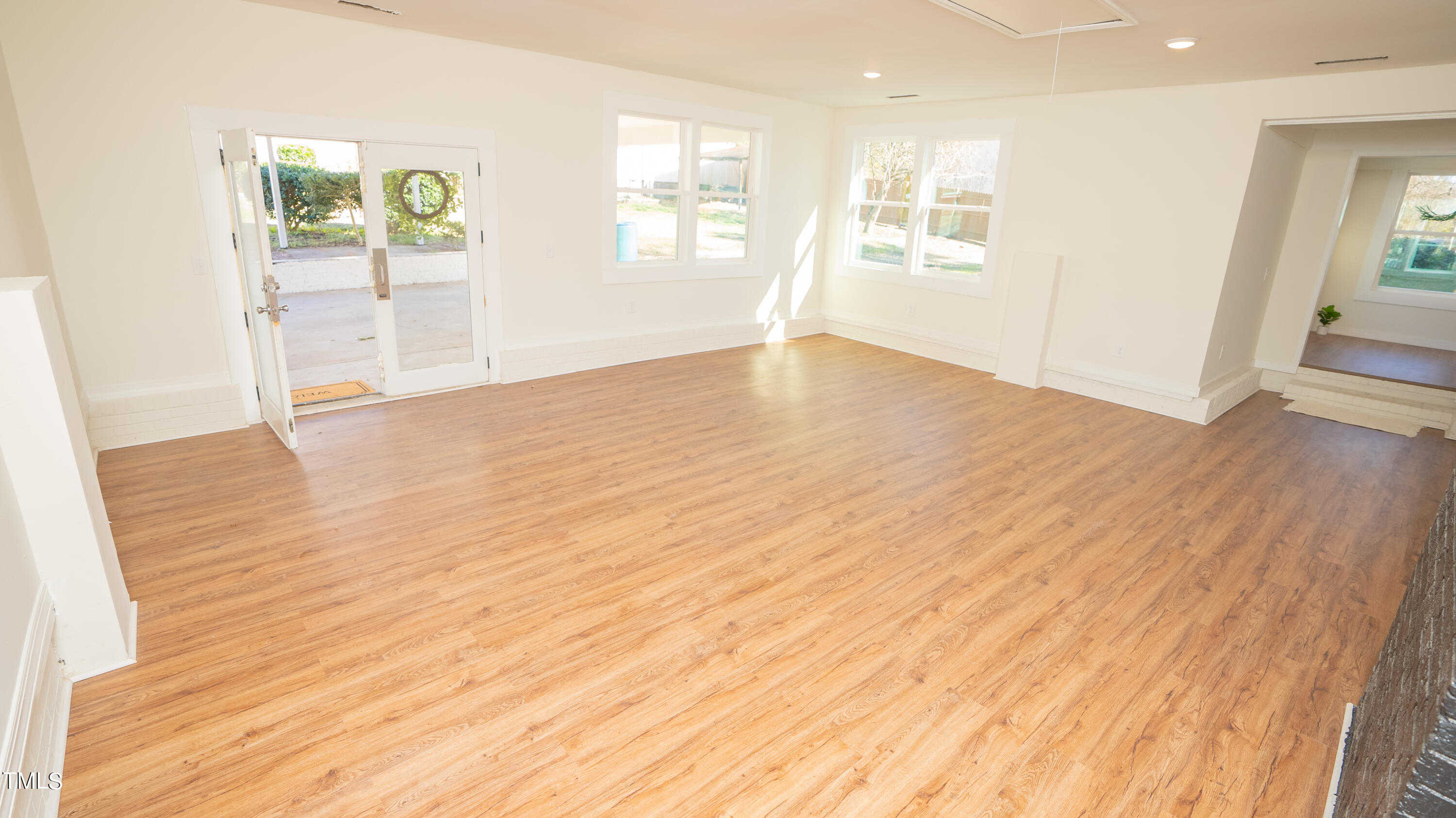 2001 Barwell Road Raleigh, NC 27610 - Photo 9 of 79 an empty room with wooden floor and windows