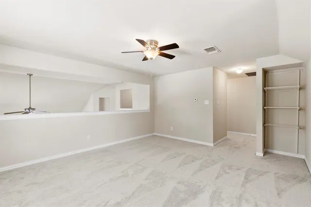 a view of walk in closet with wooden floor