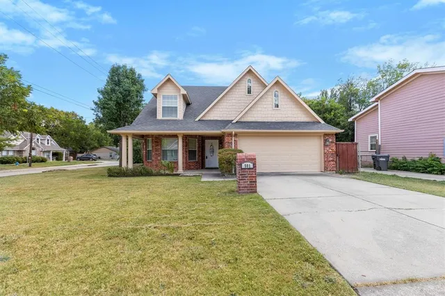 a front view of a house with a garden and porch