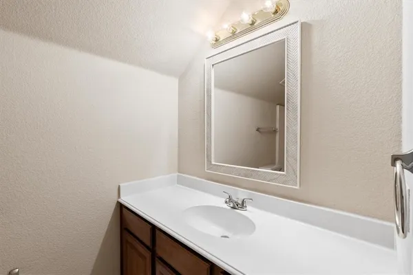 an empty room with a window and a chandelier fan