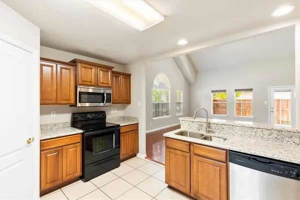 a kitchen with stainless steel appliances granite countertop a sink and cabinets