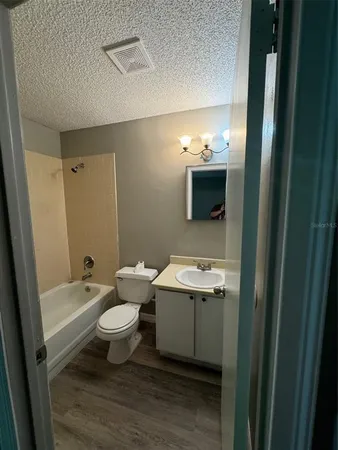 a bathroom with a sink toilet a mirror and shower