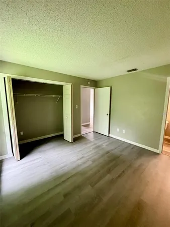 an empty room with closet and mirror