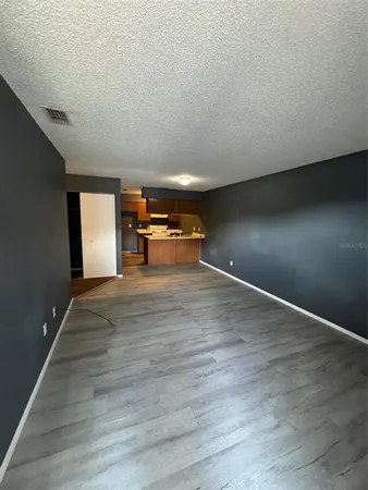 a view of a room with wooden floor