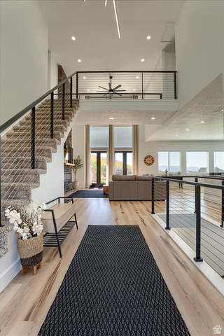 828 South Deer Road Tooele, UT 84074 - Photo 5 of 51 Expansive foyer featuring light wood-finish flooring, a carpeted staircase with contemporary cable railing, and recessed lighting