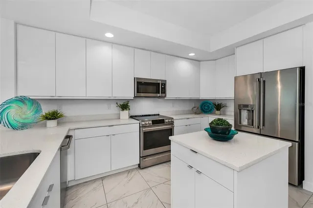 a kitchen with a sink cabinets and stainless steel appliances